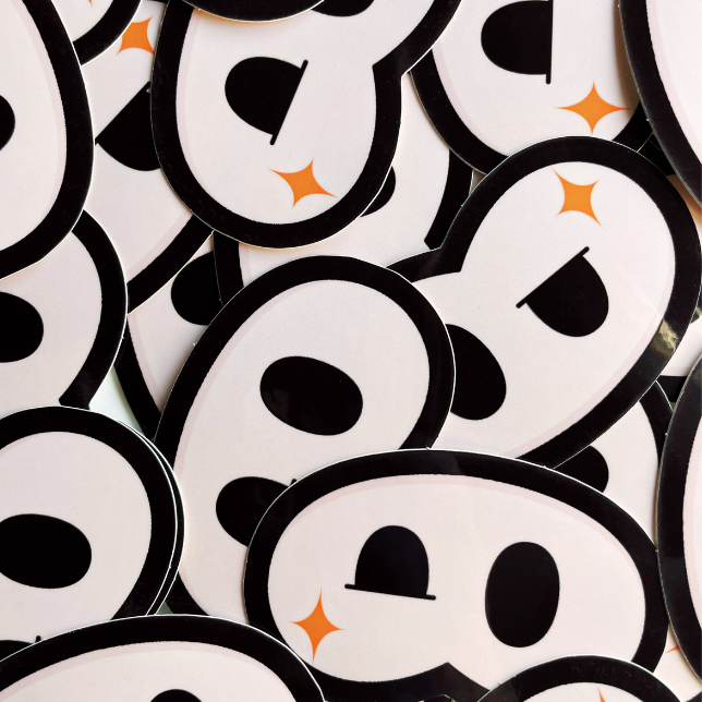 Stack of round stickers with black and white designs on a white background